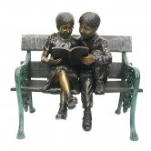 Bronze Kids sitting on a Bench Reading