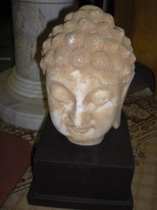 Stone Buddha head with pedestal
