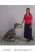 Juvenile Theropod Sitting Dinosaur Statue